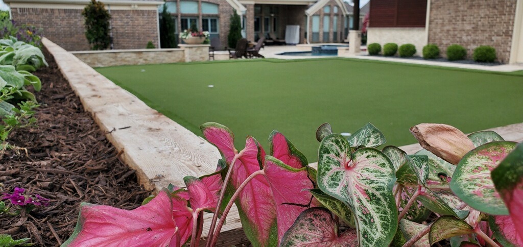 Suburban backyard with garden and artificial turf