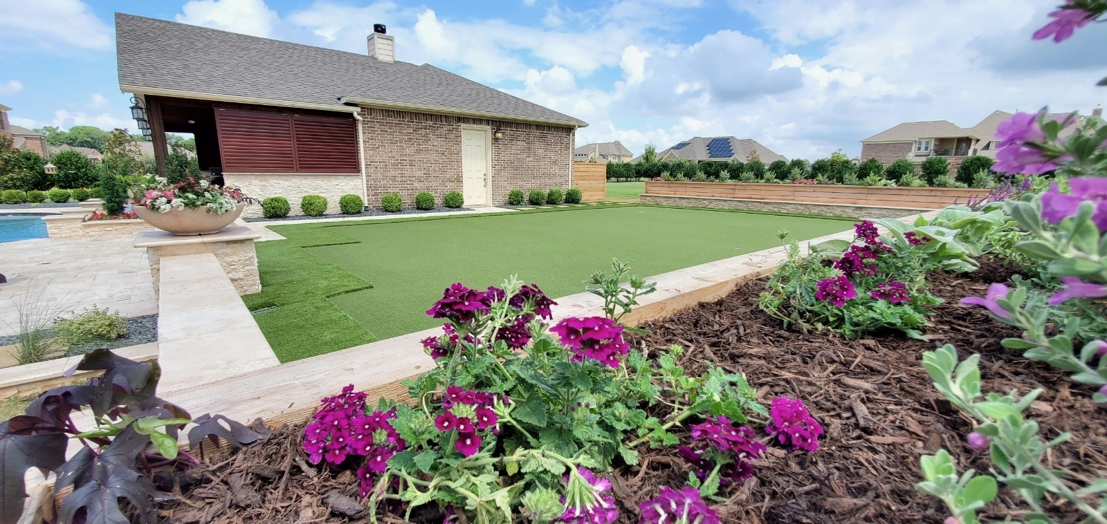 Manicured lawn with flowers in residential backyard