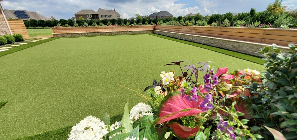 Beautiful garden with flowers and well-manicured green lawn.