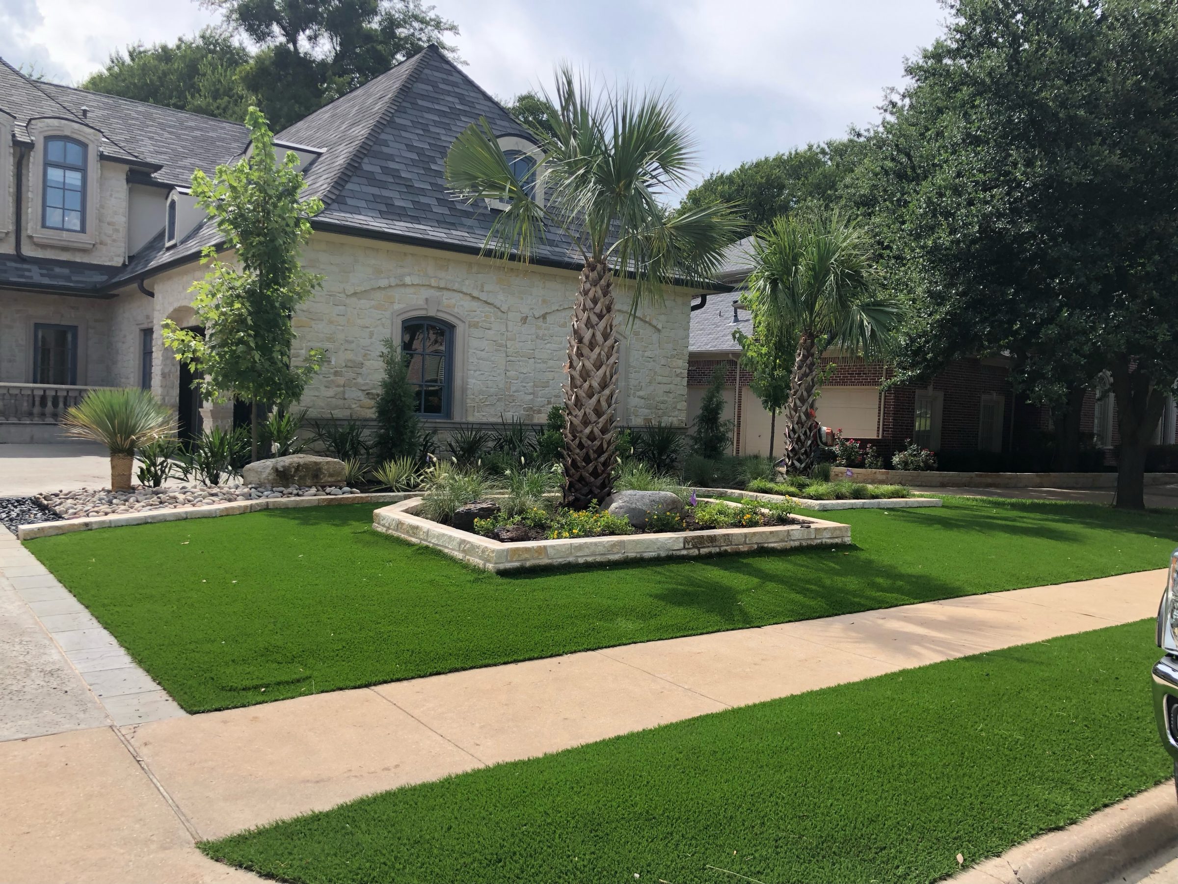 Beautiful house with manicured lawn and landscaping.