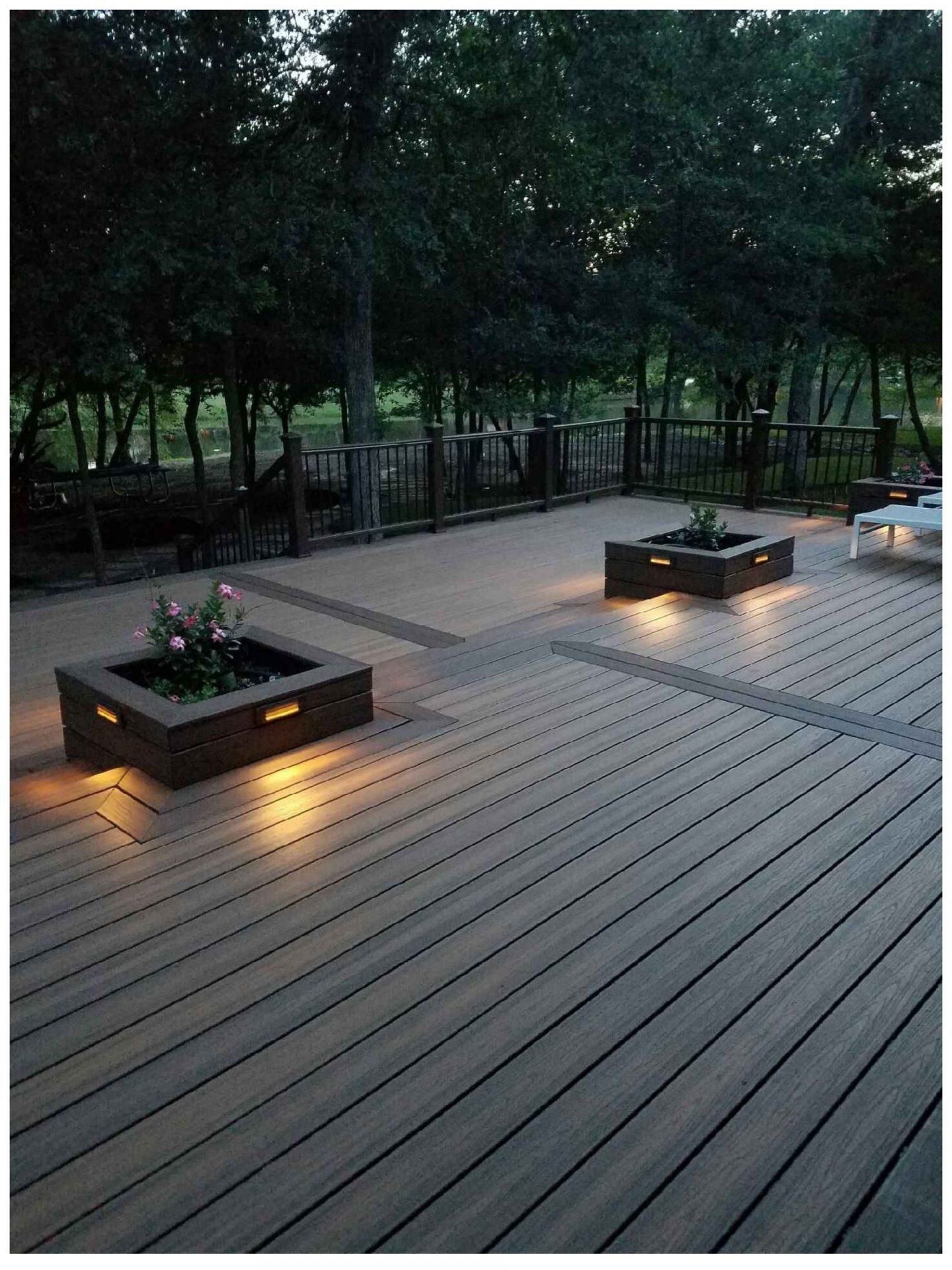 Outdoor deck with ambient lighting and planters.