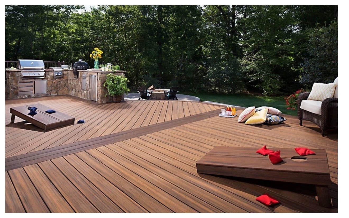 Backyard deck with grill and cornhole game.