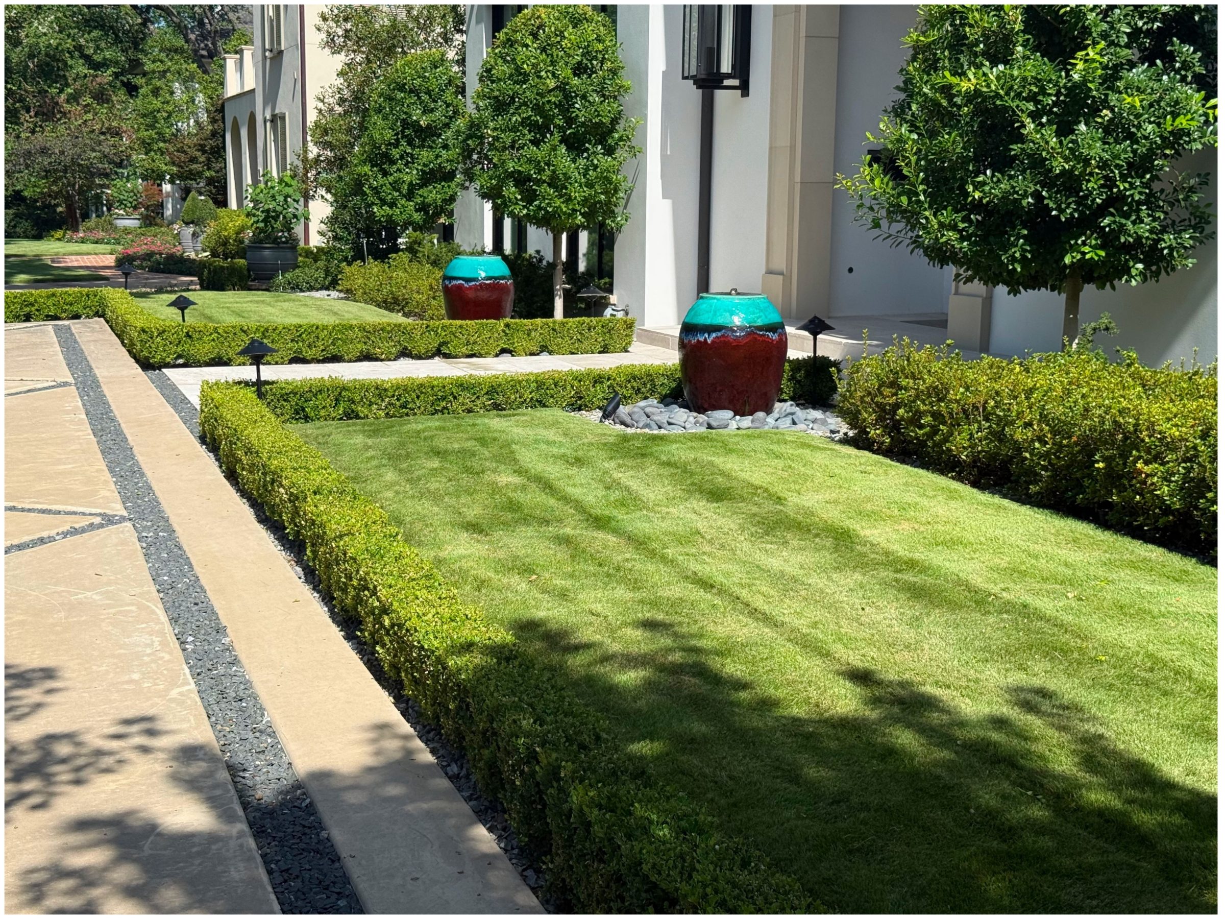 Manicured garden with decorative planters at modern building.