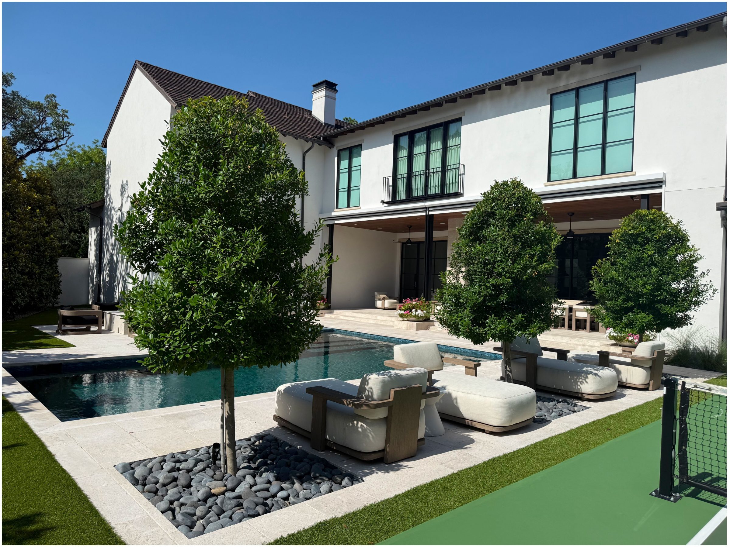 Modern house with pool and green landscaping.