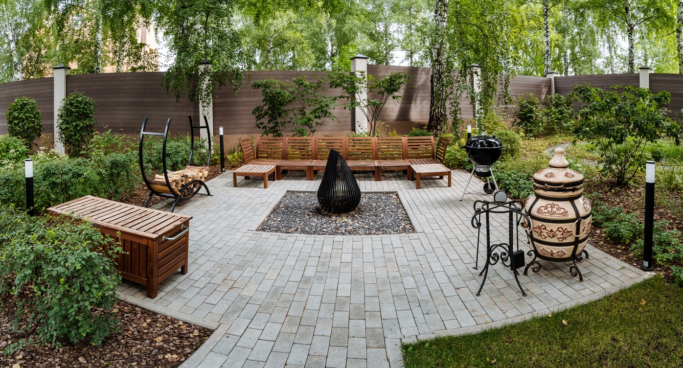 Outdoor patio with seating and grill area.