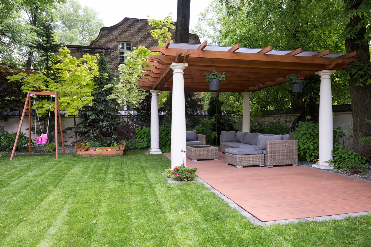 Backyard with pergola, swing, and chairs